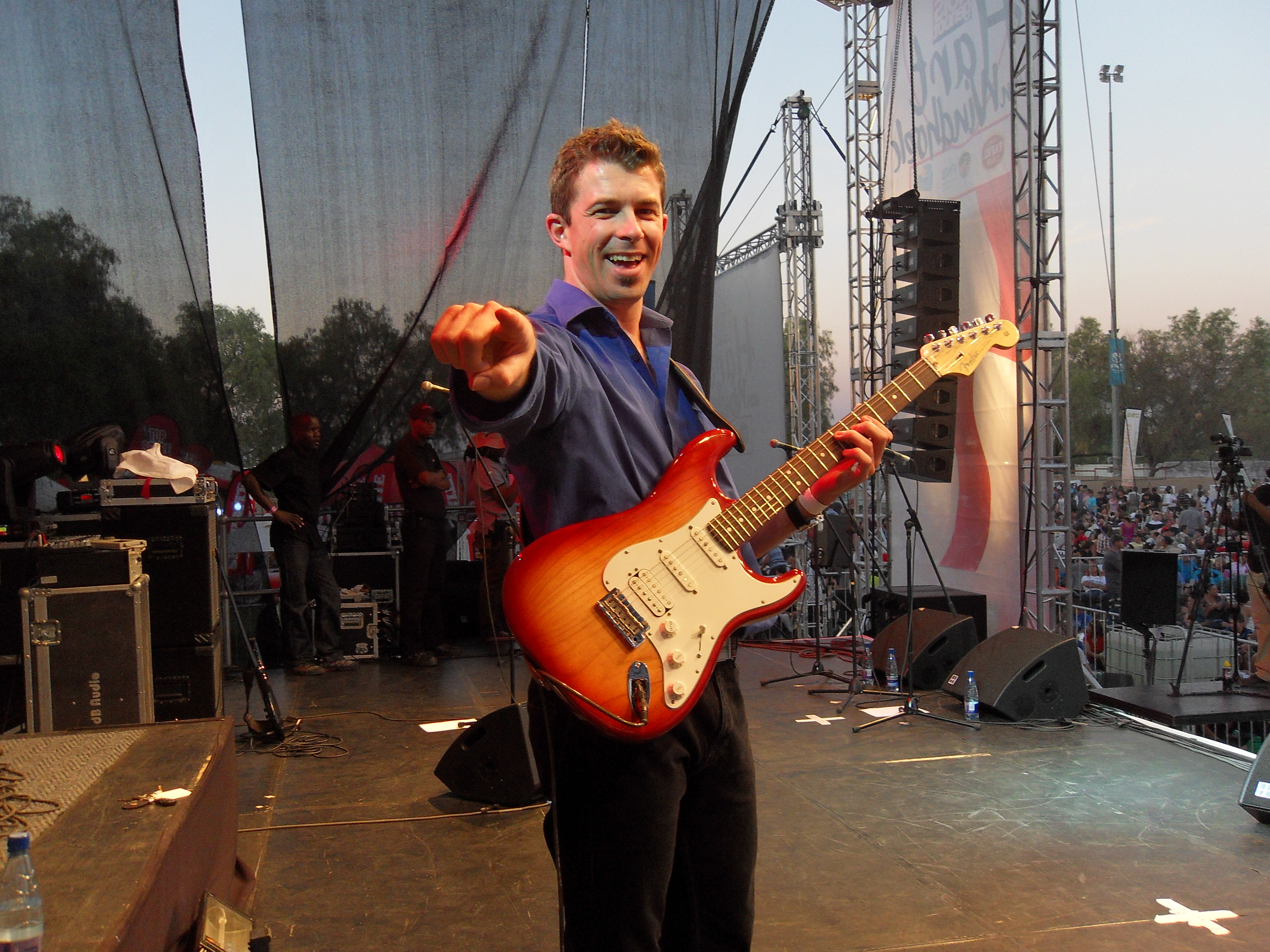 Michael Bester expressively playing an orange telecaster on stage