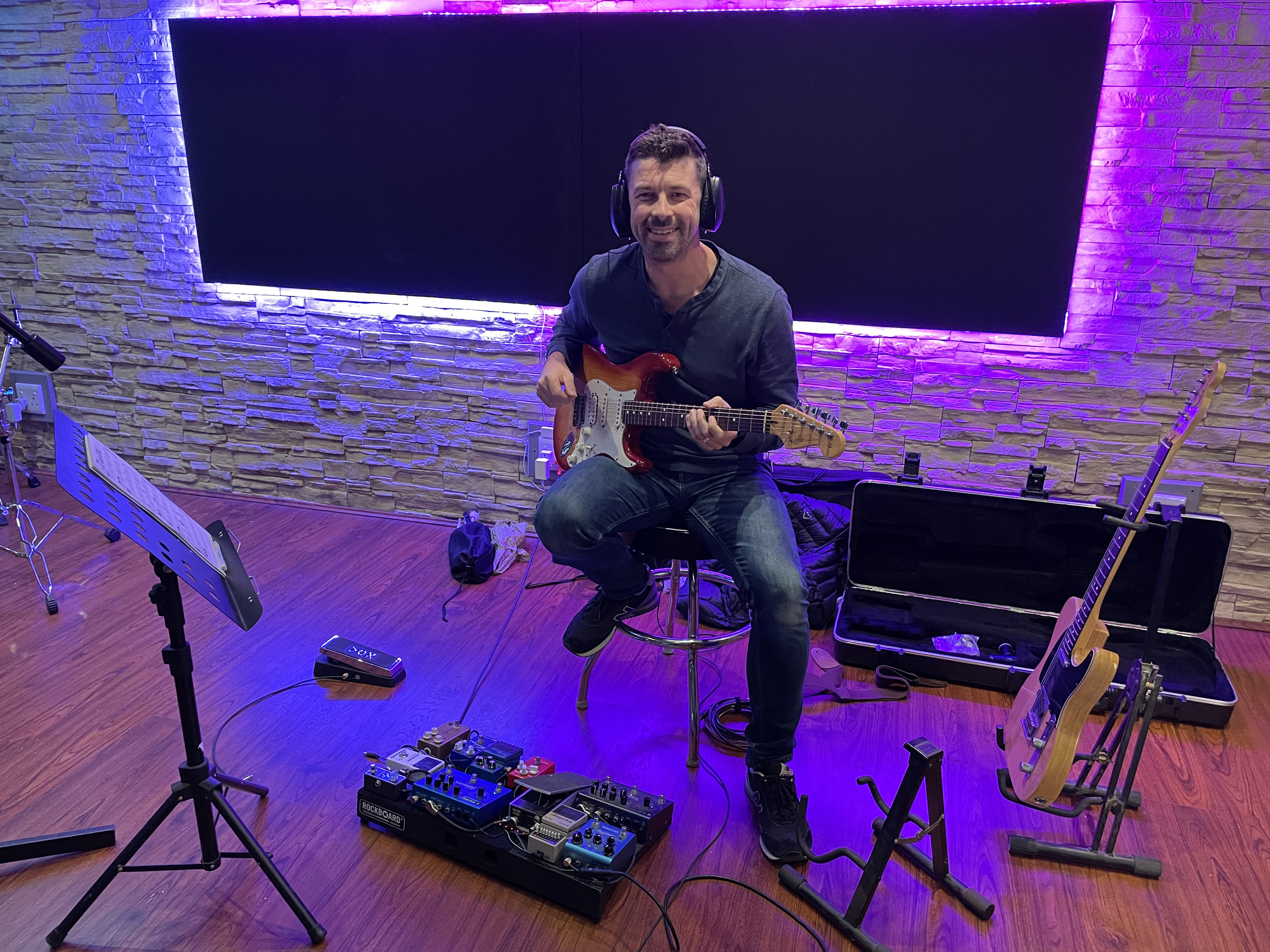 Michael Bester recording an electric guitar session in the studio with a Fender Telecaster and in-ear monitor