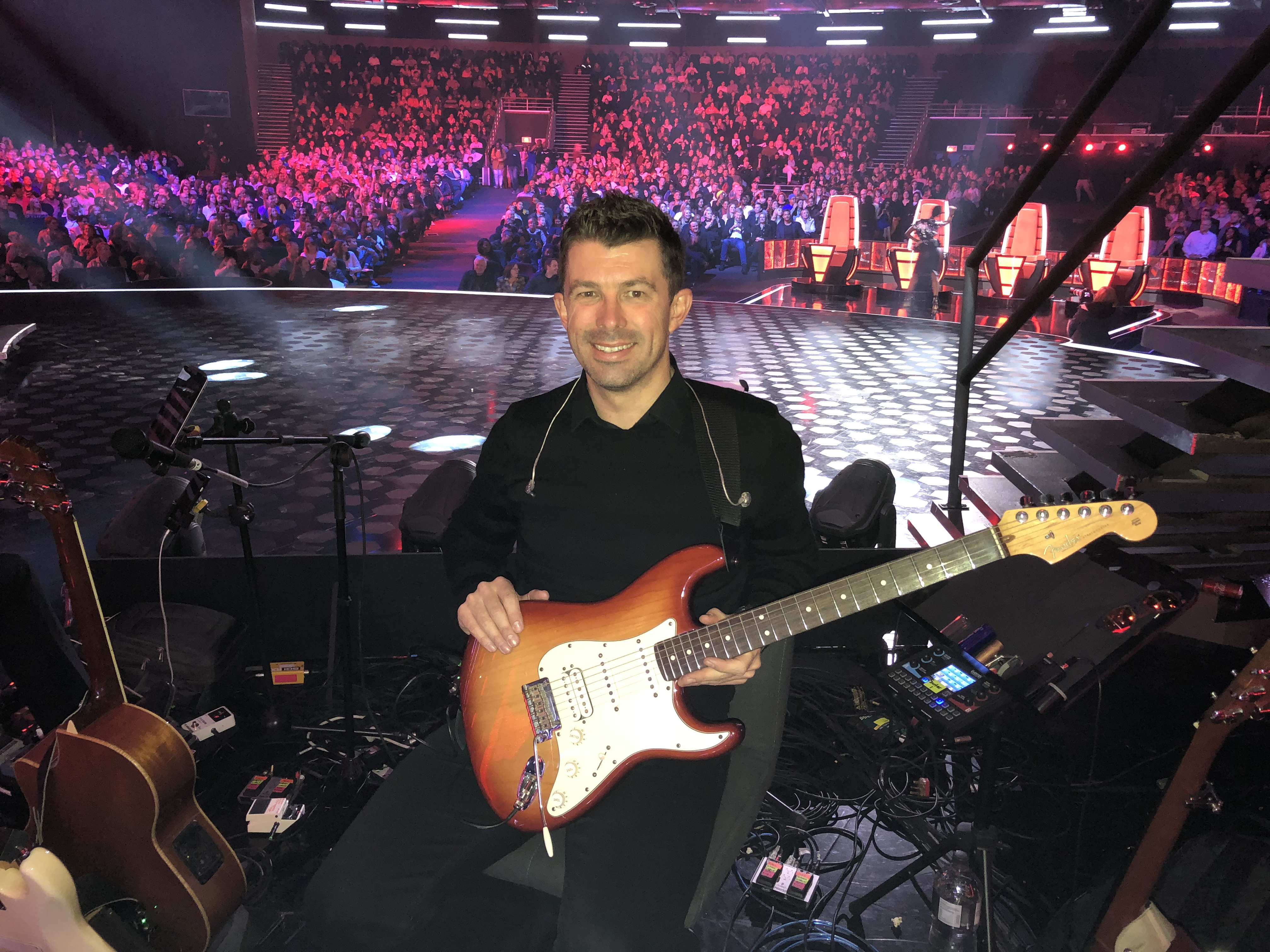 Michael Bester recording an electric guitar session in the studio with a Fender Telecaster and in-ear monitor